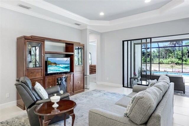 8396 Promoso Ct, Naples, FL 34114 - living area featuring a tray ceiling, baseboards, recessed lighting, light tile patterned flooring, and ornamental molding