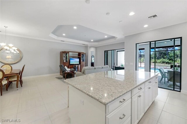 8396 Promoso Ct, Naples, FL 34114 - kitchen with a chandelier, recessed lighting, a center island, baseboards, and white cabinetry