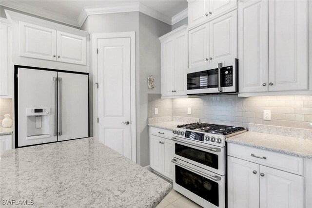 8396 Promoso Ct, Naples, FL 34114 - kitchen with white appliances, crown molding, white cabinets, tasteful backsplash, and light stone counters