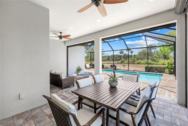 8396 Promoso Ct, Naples, FL 34114 - view of patio featuring ceiling fan, an outdoor pool, outdoor dining space, and glass enclosure