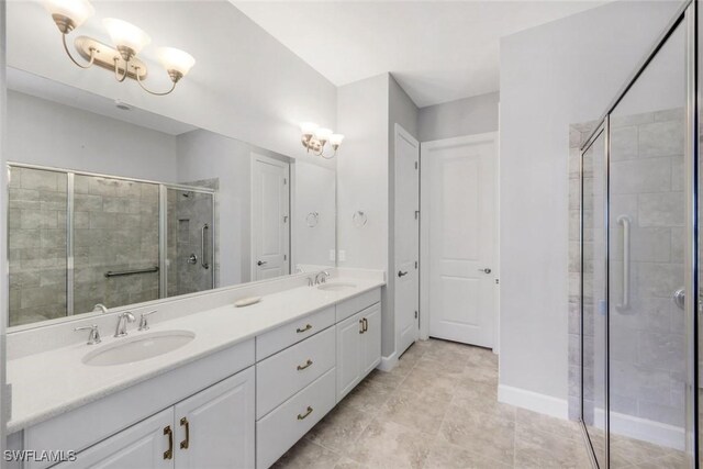 8396 Promoso Ct, Naples, FL 34114 - full bathroom featuring a stall shower, double vanity, and baseboards