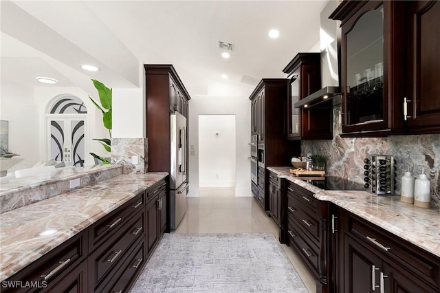 221 10th St SE, Naples, FL 34117 - kitchen featuring high quality fridge, black electric stovetop, tasteful backsplash, dark brown cabinetry, and light stone counters