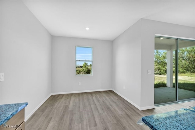 1414 NE 6th Ave, Cape Coral, FL 33909 - unfurnished room featuring wood finished floors, baseboards, and recessed lighting