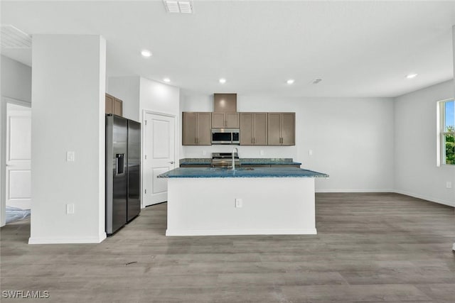 1414 NE 6th Ave, Cape Coral, FL 33909 - kitchen featuring appliances with stainless steel finishes, dark countertops, baseboards, recessed lighting, and an island with sink