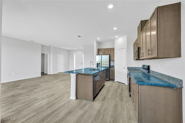 1414 NE 6th Ave, Cape Coral, FL 33909 - kitchen featuring stainless steel appliances, a sink, light wood finished floors, recessed lighting, and open floor plan