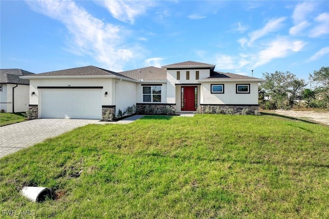 1414 NE 6th Ave, Cape Coral, FL 33909 - prairie-style home with stucco siding, stone siding, an attached garage, decorative driveway, and a front yard