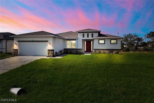 1414 NE 6th Ave, Cape Coral, FL 33909 - prairie-style home with stucco siding, a garage, decorative driveway, a front lawn, and stone siding