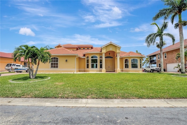 6140 River Shore Ct, North Fort Myers, FL 33917 - mediterranean / spanish-style home with a tiled roof, stucco siding, and a front yard