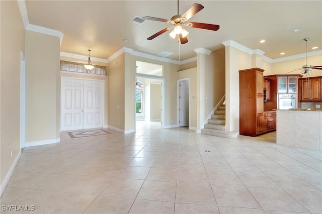 6140 River Shore Ct, North Fort Myers, FL 33917 - unfurnished living room with ceiling fan, stairway, crown molding, light tile patterned floors, and plenty of natural light