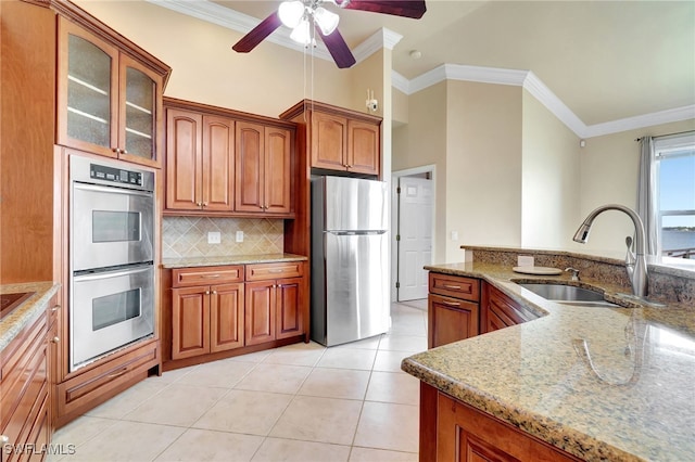 6140 River Shore Ct, North Fort Myers, FL 33917 - kitchen with stainless steel appliances, a sink, glass insert cabinets, ornamental molding, and backsplash