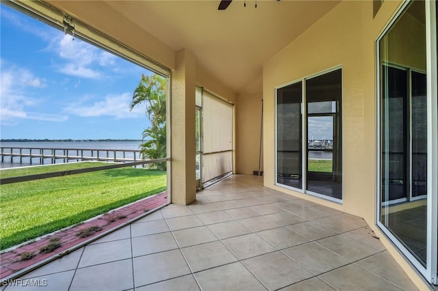 6140 River Shore Ct, North Fort Myers, FL 33917 - unfurnished sunroom with a water view, tile patterned floors, a ceiling fan, lofted ceiling, and beverage cooler