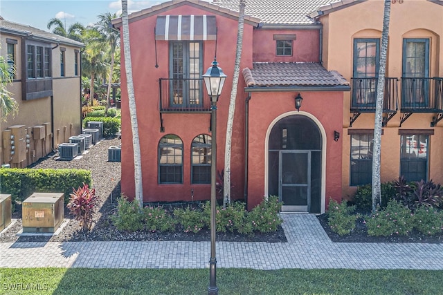 8163 Bibiana Way Unit 301, Fort Myers, FL 33912 - view of front of house with a tile roof, a balcony, stucco siding, and central air condition unit