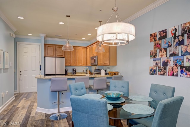 8163 Bibiana Way Unit 301, Fort Myers, FL 33912 - dining room featuring ornamental molding, recessed lighting, wood finished floors, and baseboards