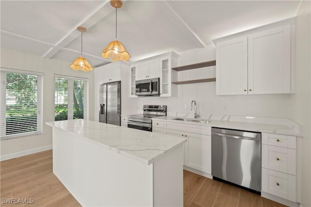 280 4th St S Unit 104, Naples, FL 34102 - kitchen with appliances with stainless steel finishes, a sink, a kitchen island, open shelves, and beamed ceiling