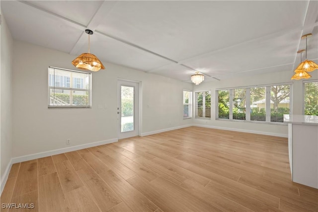 280 4th St S Unit 104, Naples, FL 34102 - unfurnished dining area featuring baseboards and light wood-style flooring