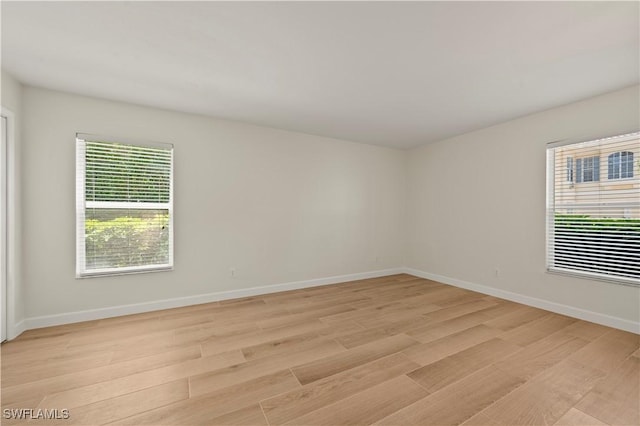 280 4th St S Unit 104, Naples, FL 34102 - empty room featuring light wood-style floors and baseboards
