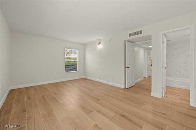 280 4th St S Unit 104, Naples, FL 34102 - empty room with light wood-style floors and baseboards