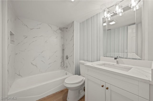 280 4th St S Unit 104, Naples, FL 34102 - bathroom with wood finished floors, vanity,  shower combination, and toilet