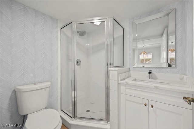 280 4th St S Unit 104, Naples, FL 34102 - full bath with toilet, a shower stall, vanity, and wallpapered walls