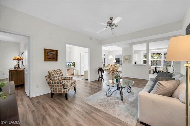 600 Diamond Cir Unit 607, Naples, FL 34110 - living room with wood finished floors, a ceiling fan, and baseboards