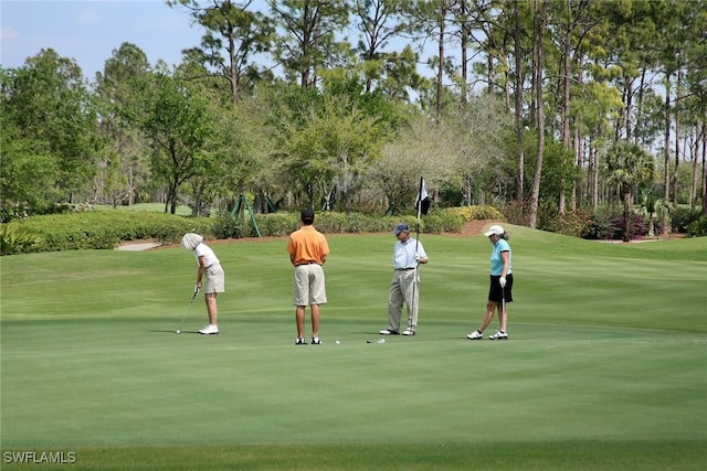 600 Diamond Cir Unit 607, Naples, FL 34110 - view of community featuring a lawn, view of wooded area, and view of golf course