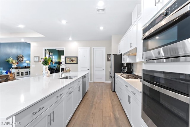 20467 Napa Loop, Estero, FL 33928 - kitchen with a sink, appliances with stainless steel finishes, light countertops, white cabinetry, and recessed lighting