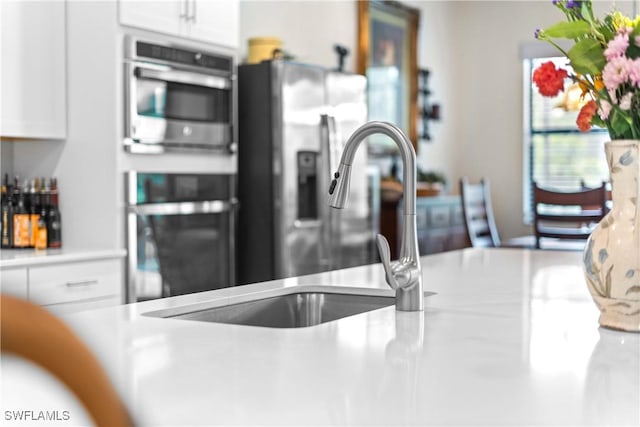 20467 Napa Loop, Estero, FL 33928 - kitchen view of white cabinets, light countertops, appliances with stainless steel finishes, and a sink
