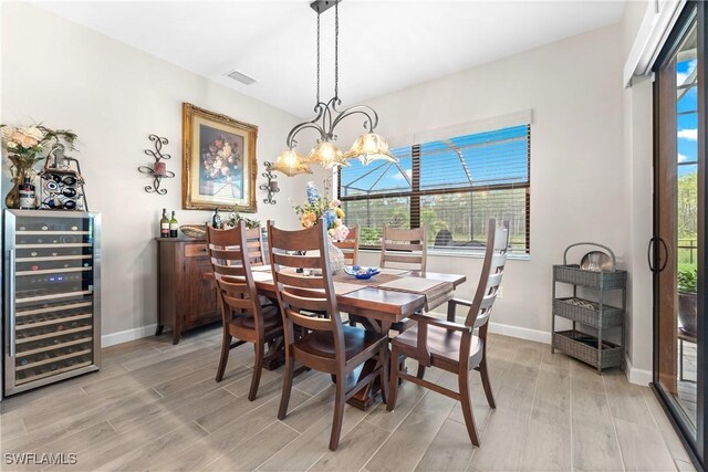 20467 Napa Loop, Estero, FL 33928 - dining area with beverage cooler, light wood-type flooring, and baseboards