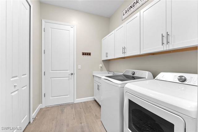20467 Napa Loop, Estero, FL 33928 - washroom with washer and clothes dryer, light wood-type flooring, baseboards, and cabinet space