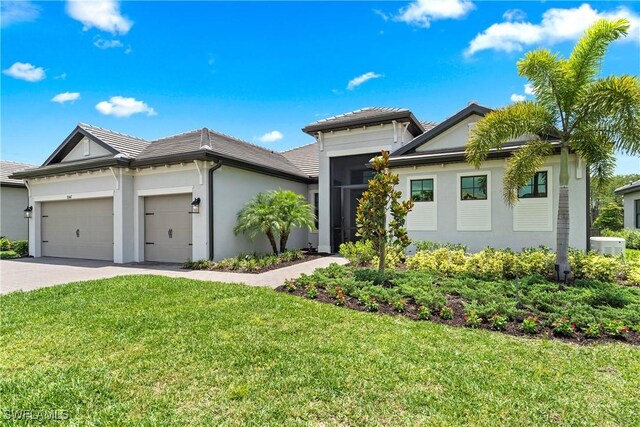 20467 Napa Loop, Estero, FL 33928 - view of front of house with an attached garage, stucco siding, a front yard, driveway, and a tiled roof
