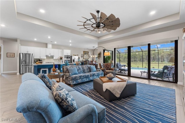 20467 Napa Loop, Estero, FL 33928 - living room with a raised ceiling, baseboards, light wood finished floors, ceiling fan, and recessed lighting