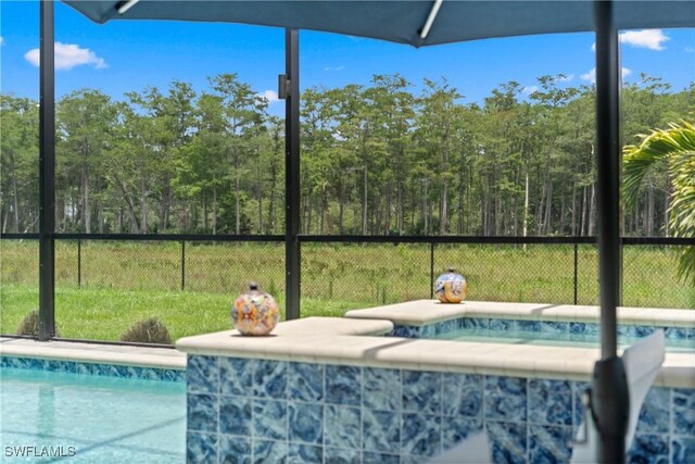 20467 Napa Loop, Estero, FL 33928 - view of pool with an in-ground hot tub and a wooded view