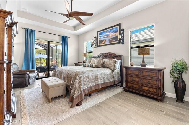 20467 Napa Loop, Estero, FL 33928 - bedroom with access to outside, a raised ceiling, wood finish floors, ceiling fan, and baseboards