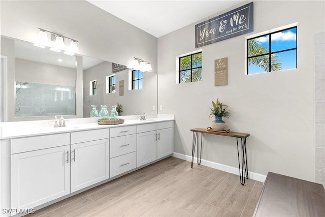 20467 Napa Loop, Estero, FL 33928 - bathroom with double vanity, wood finished floors, baseboards, and walk in shower