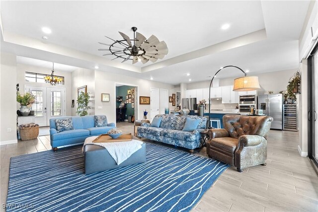20467 Napa Loop, Estero, FL 33928 - living room featuring a tray ceiling, light wood-style floors, baseboards, recessed lighting, and a ceiling fan