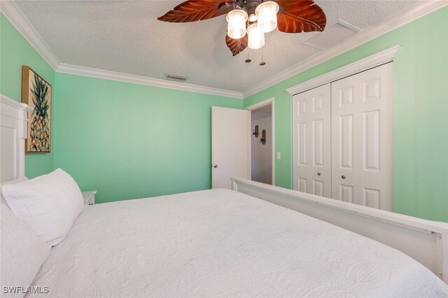 3586 Santiago Way, Naples, FL 34105 - bedroom with ornamental molding, a closet, a textured ceiling, and ceiling fan