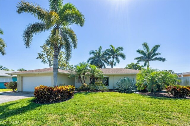 3586 Santiago Way, Naples, FL 34105 - single story home with an attached garage, stucco siding, and a front lawn