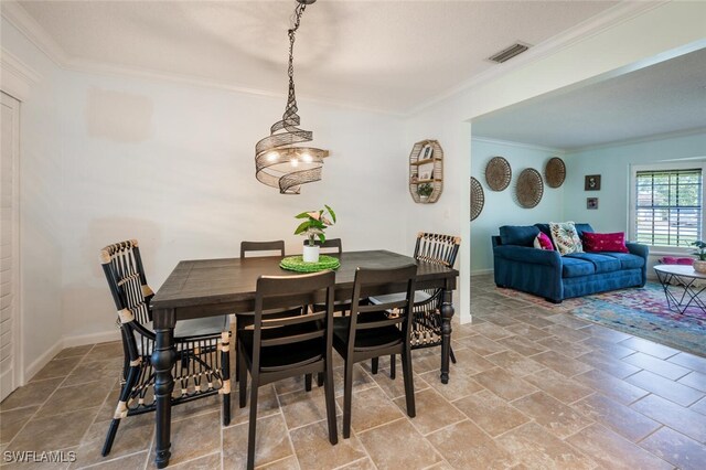3586 Santiago Way, Naples, FL 34105 - dining space featuring crown molding, stone finish floors, and baseboards
