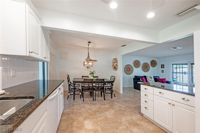 3586 Santiago Way, Naples, FL 34105 - kitchen featuring baseboards, white cabinetry, white dishwasher, dark stone countertops, and hanging light fixtures