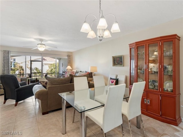 11921 Seabreeze Cove Ln Unit 104, Fort Myers, FL 33908 - dining area with a chandelier, light tile patterned flooring, and ceiling fan