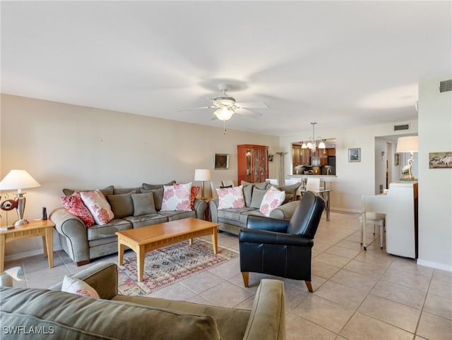 11921 Seabreeze Cove Ln Unit 104, Fort Myers, FL 33908 - living room featuring ceiling fan, a chandelier, light tile patterned floors, and baseboards