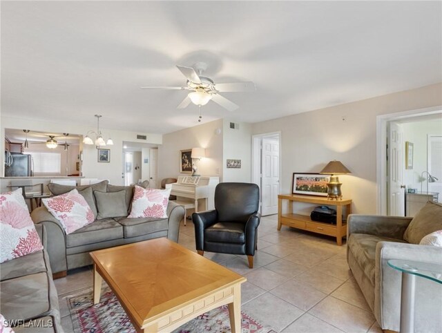 11921 Seabreeze Cove Ln Unit 104, Fort Myers, FL 33908 - living area featuring ceiling fan, light tile patterned floors, and a chandelier