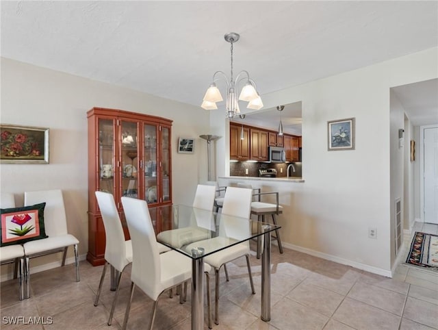 11921 Seabreeze Cove Ln Unit 104, Fort Myers, FL 33908 - dining room featuring a chandelier, light tile patterned flooring, and baseboards