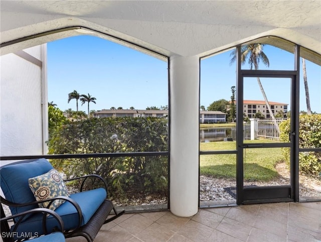 11921 Seabreeze Cove Ln Unit 104, Fort Myers, FL 33908 - sunroom / solarium featuring lofted ceiling and a water view