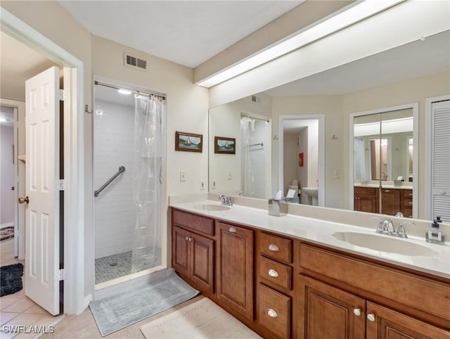 11921 Seabreeze Cove Ln Unit 104, Fort Myers, FL 33908 - bathroom featuring a stall shower, tile patterned flooring, and double vanity