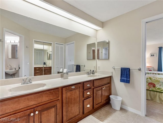 11921 Seabreeze Cove Ln Unit 104, Fort Myers, FL 33908 - ensuite bathroom with tile patterned floors, baseboards, and double vanity