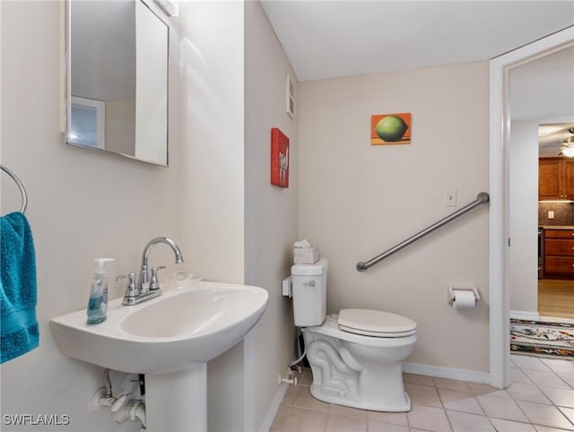 11921 Seabreeze Cove Ln Unit 104, Fort Myers, FL 33908 - bathroom with toilet, tile patterned floors, baseboards, a sink, and ceiling fan