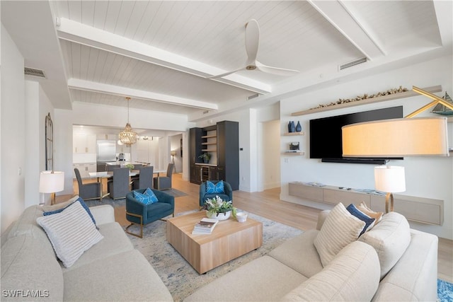 875 6th Ave S Unit 304, Naples, FL 34102 - living room with light wood finished floors, beamed ceiling, a ceiling fan, and wood ceiling