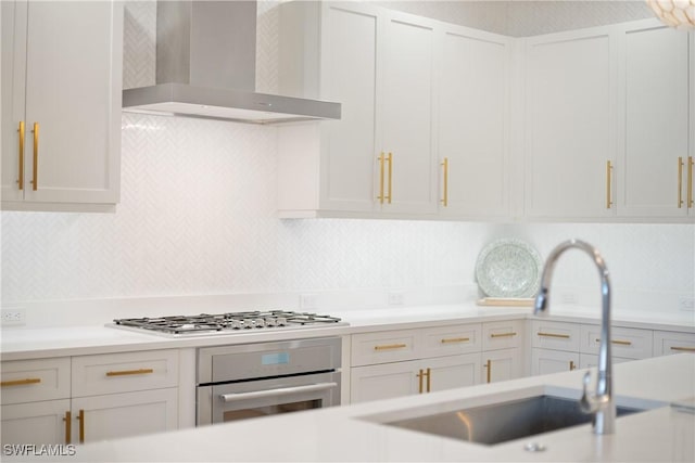875 6th Ave S Unit 304, Naples, FL 34102 - kitchen featuring wall chimney exhaust hood, stainless steel appliances, a sink, and light countertops