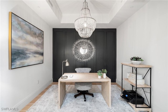 875 6th Ave S Unit 304, Naples, FL 34102 - office area featuring a chandelier, light wood-type flooring, baseboards, and a raised ceiling